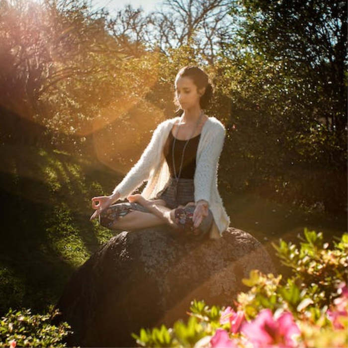 Image of a woman meditating during mindfulness practice for mental health and well-being